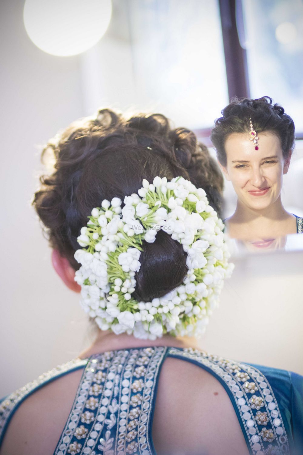 Photo of Bridal Bun with Brided Crown and Flowers