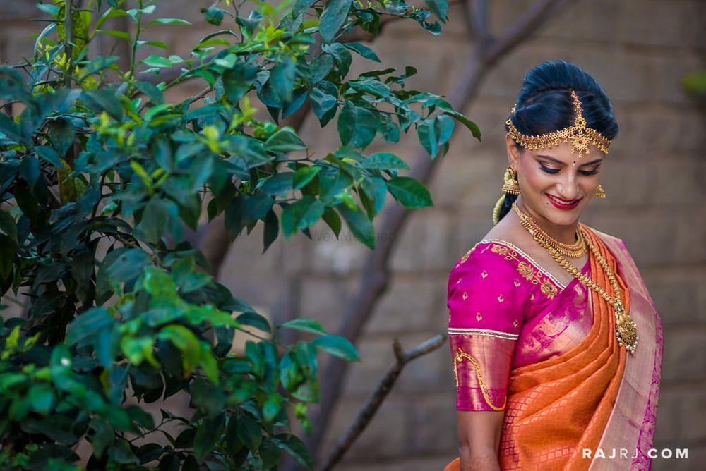 Photo of South Indian Bride in Orange and Pink Saree