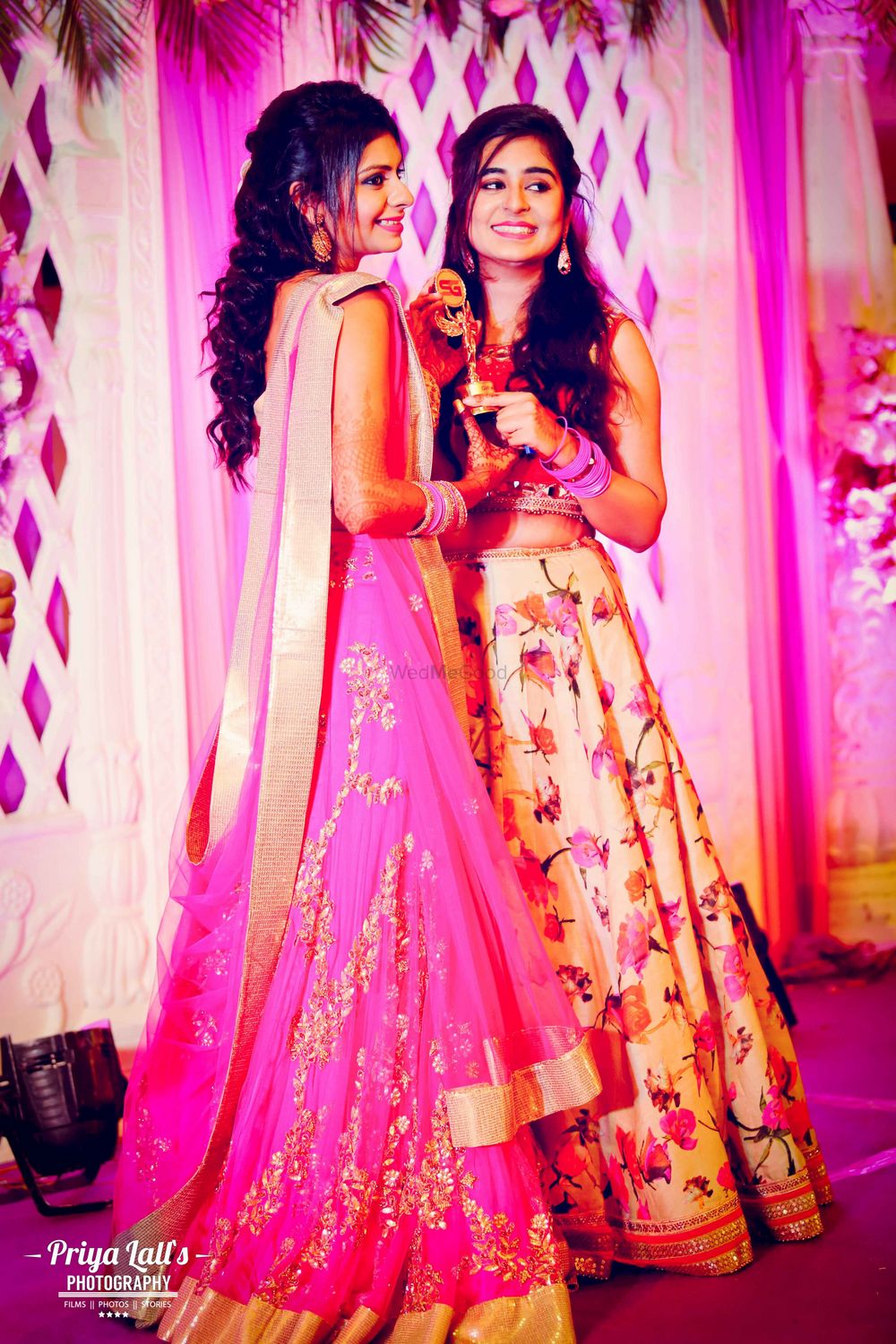 Photo of Bright pink and light pink floral lehengas