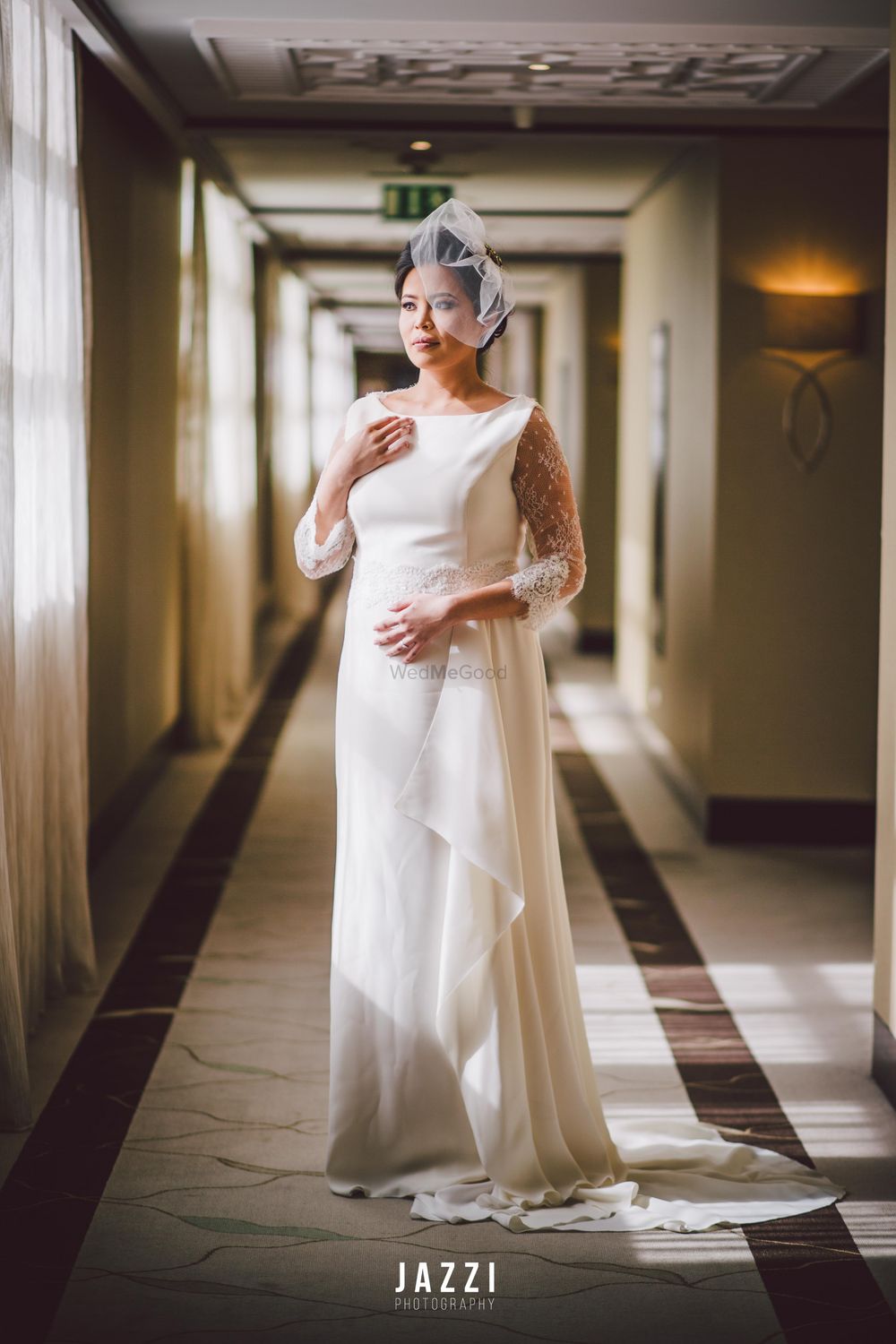 Photo of White silk wedding gown with unique veil