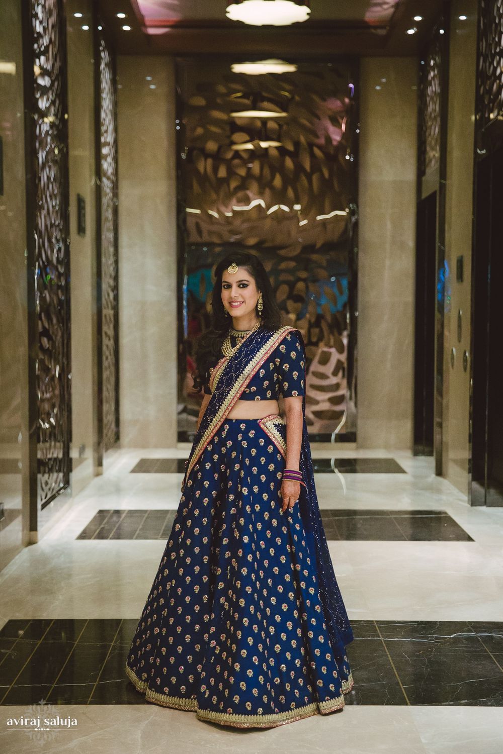 Photo of Navy blue lehenga with gold motifs and border