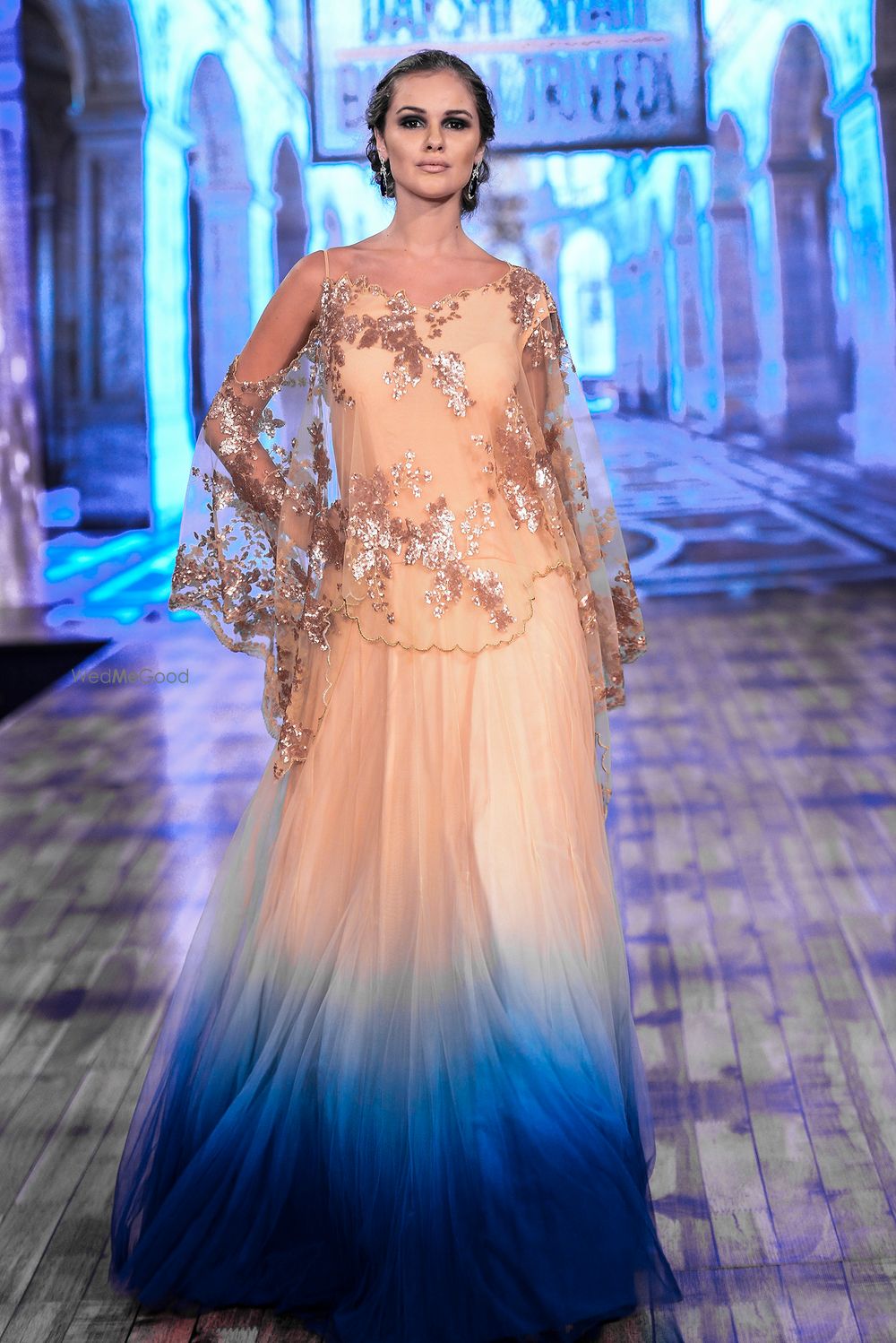 Photo of Peach and blue dip dyed gown with net cape on top