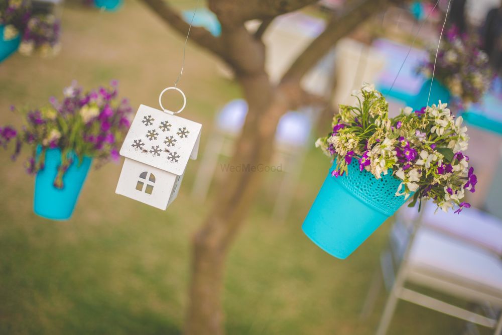 Photo of Hanging planters with floral arrangements