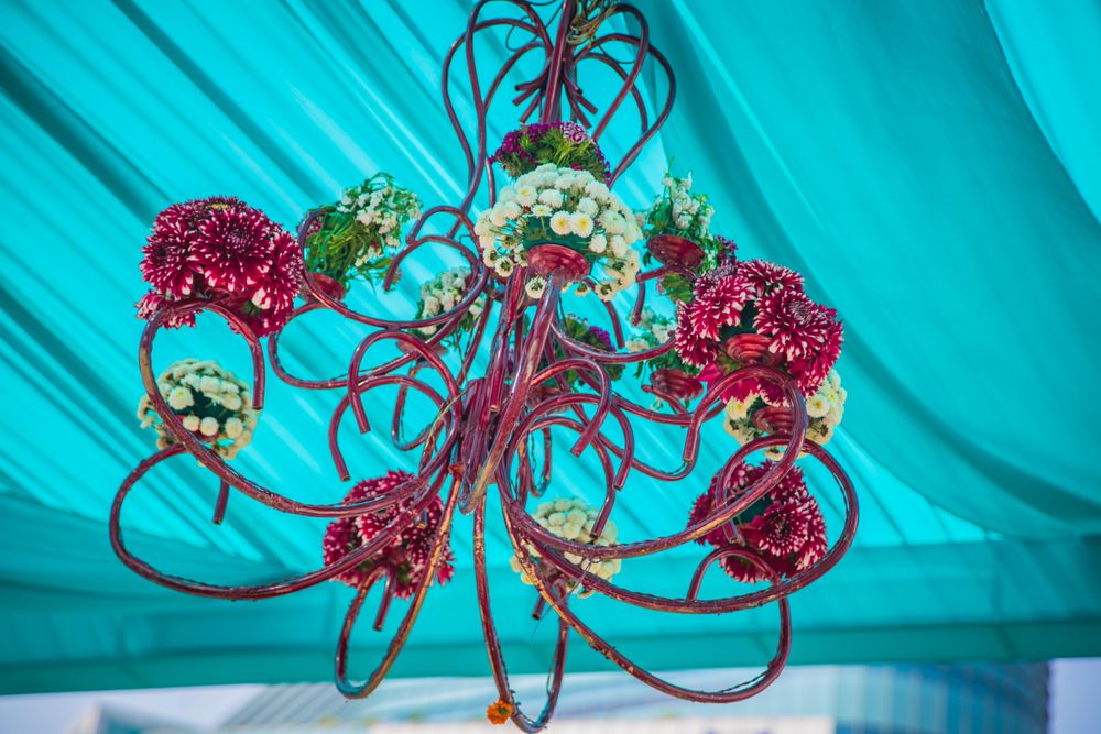 Photo of Blue tent with floral pink chandelier