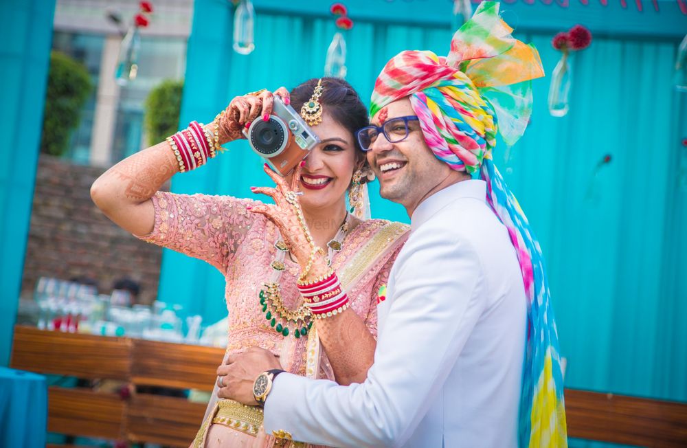 Photo of Couple portrait with bride holding camera
