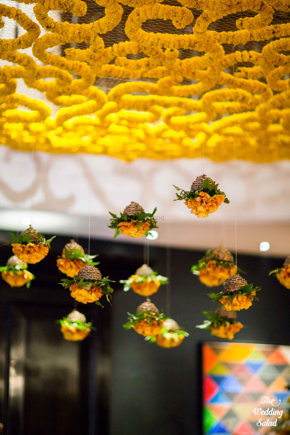 Photo of Floral hanging ceiling arrangements with suspended genda flowers