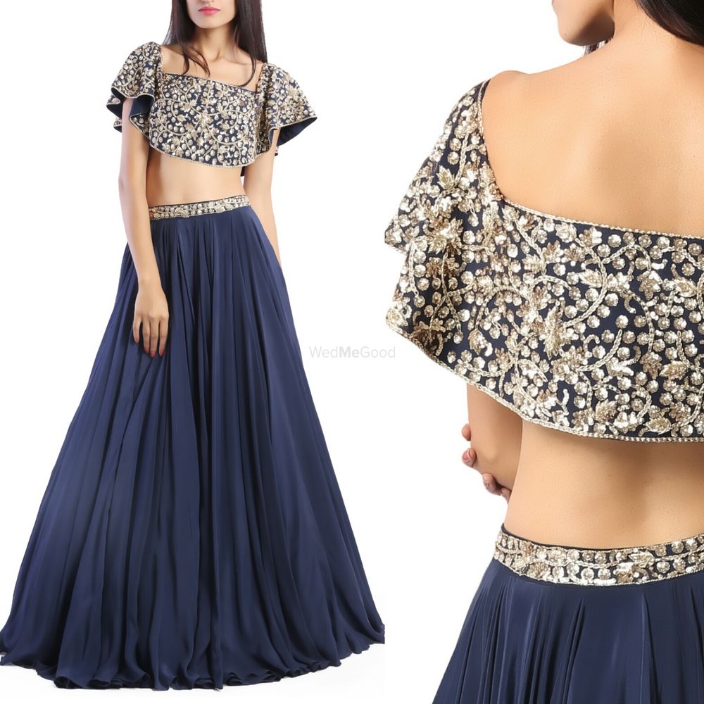 Photo of Navy blue light lehenga with cape and silver motifs
