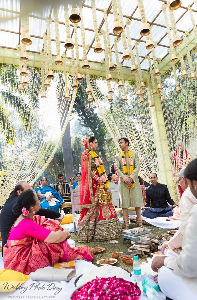 Photo of Mandap with hanging flower strings and temple bells