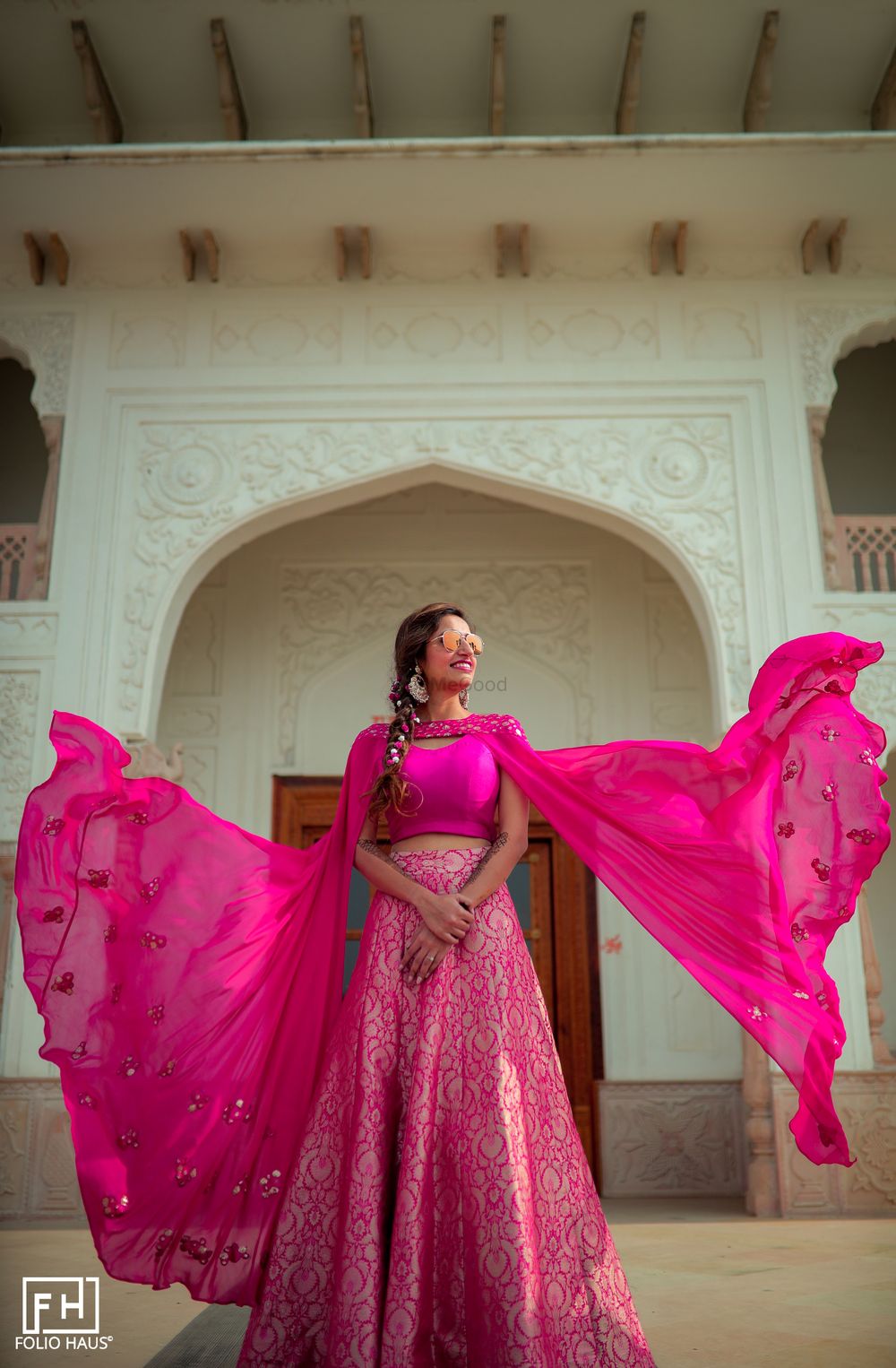 Photo of The bride dressed in a banarasi lehenga with a cape-sleeved blouse.