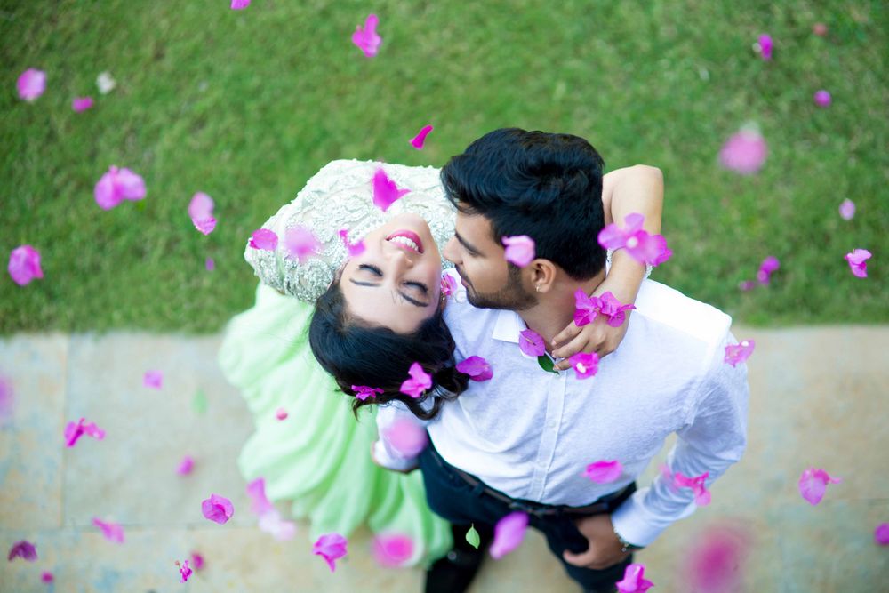Photo of Couple portrait with falling flower petals