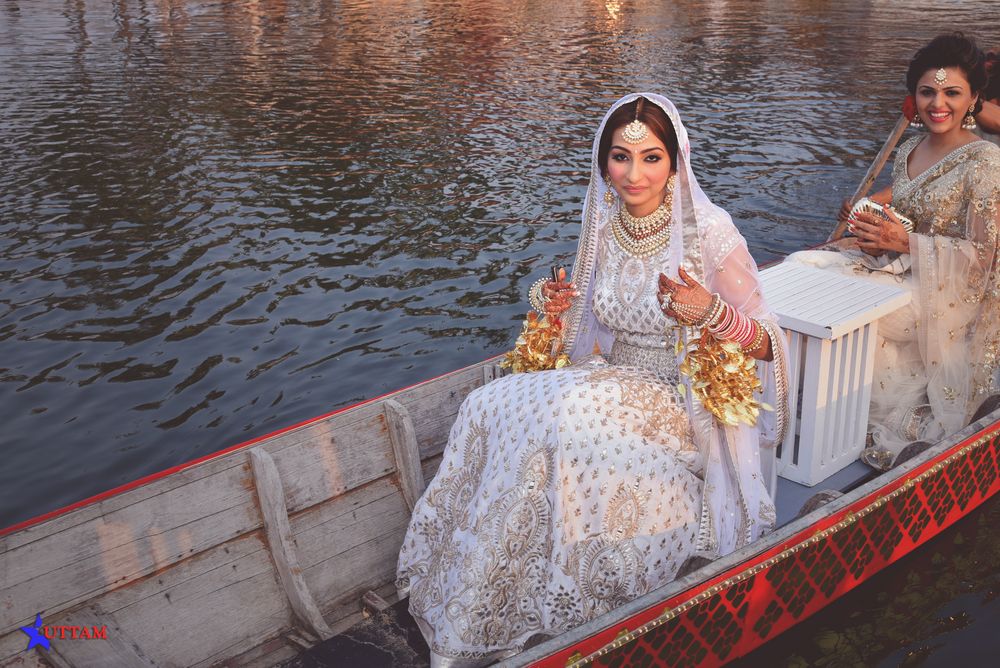 Photo of Bridal entry in a shikara boat over water