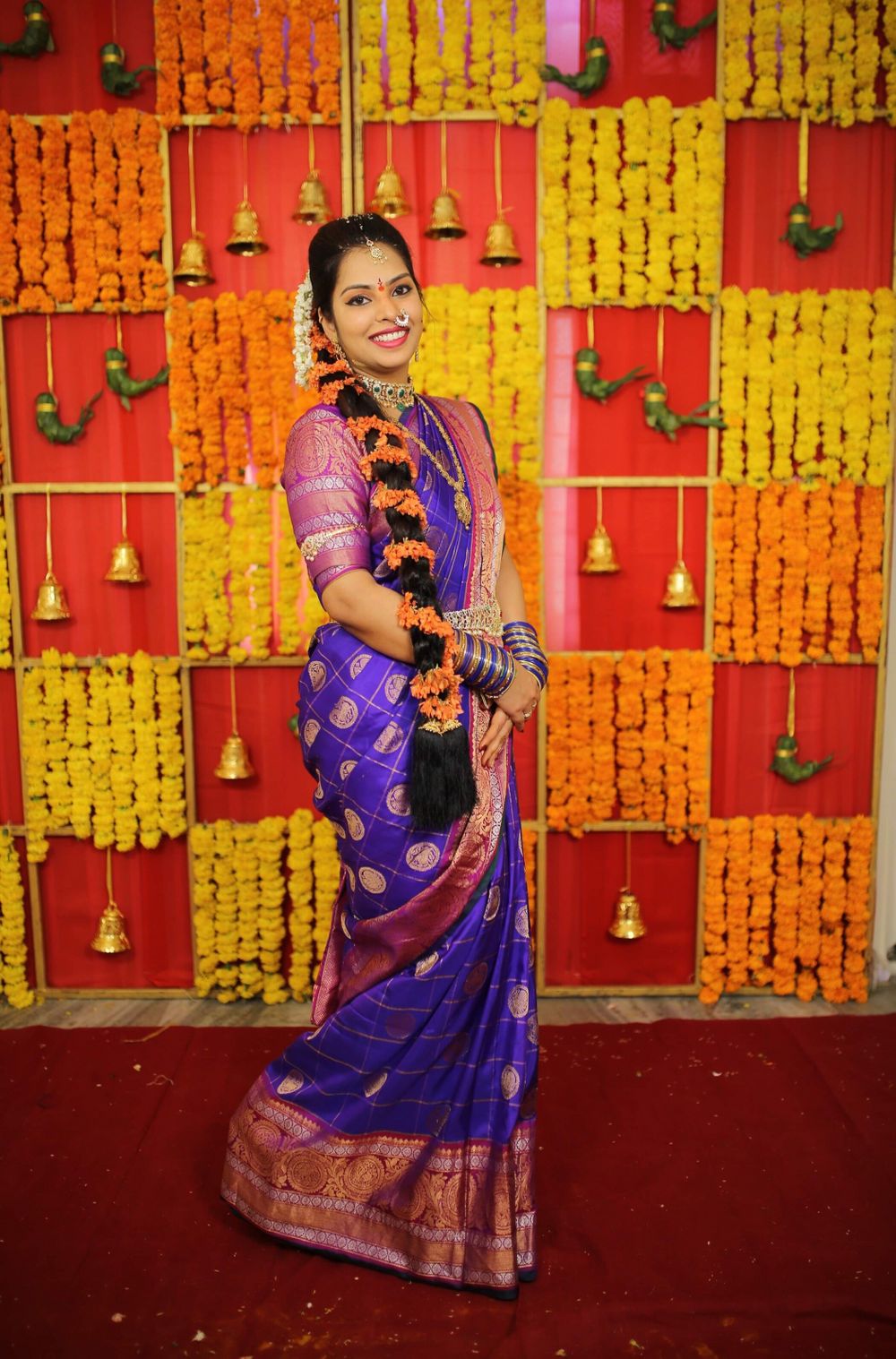 Photo of A south Indian bride in a purple kanjeevaram and marigold in her hair