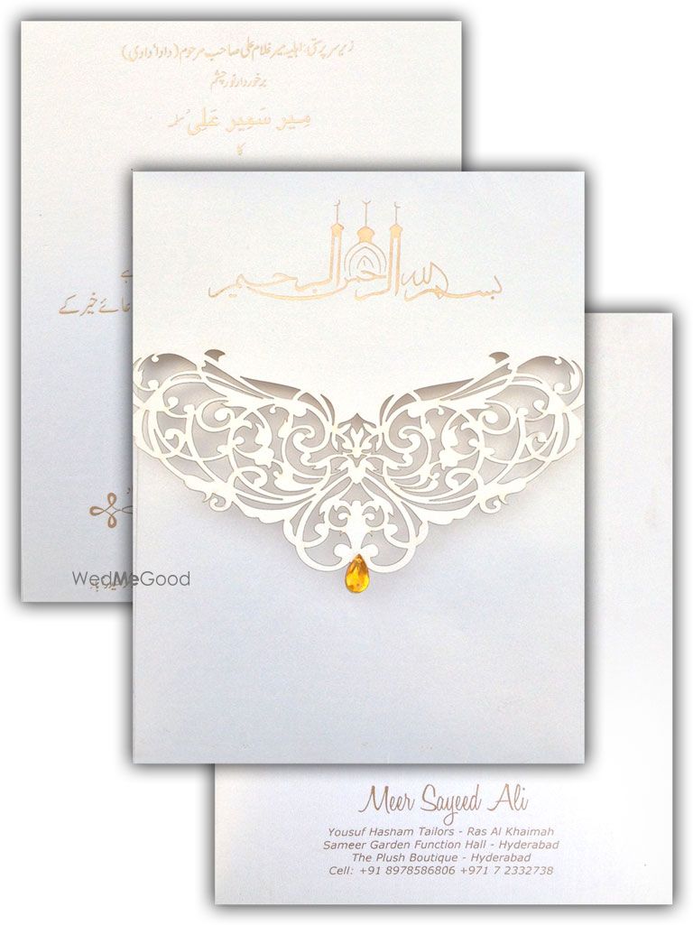 Photo of white elegant laser cut invitation cards