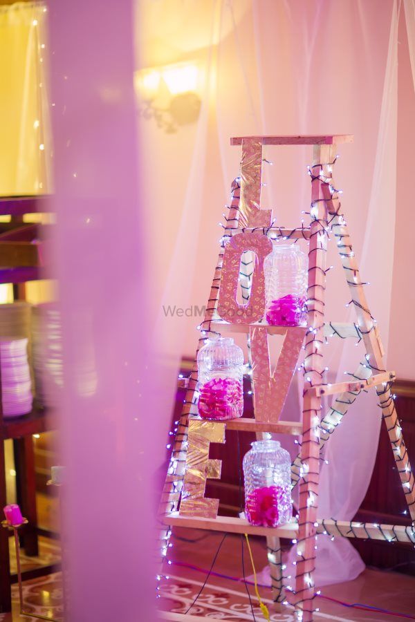 Photo of Corner decor with ladder and love monogram blocks