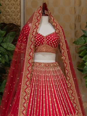 Red bridal royal motifs lehenga by Bhasin Brothers