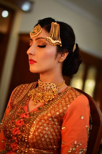 Photo of Bride Wearing Gold Jhoomer and Maangtikka and Choker
