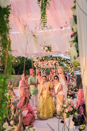 A beautiful bridal entry picture under a phoolon ki chaadar