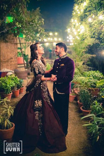 Photo of Deep wine colored bride and groom portrait