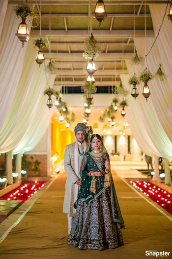 A bride and groom pose together on their wedding day
