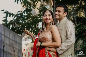 Photo of A to be bride and groom pose together on their mehndi