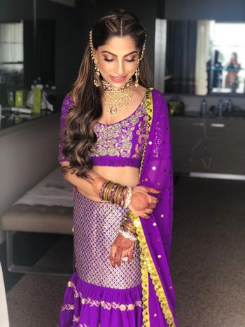 Photo of Mehendi bridal look in purple lehnga