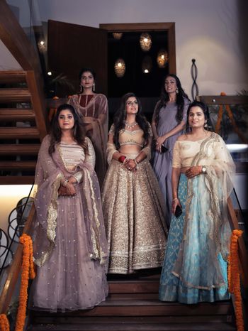 Photo of bride with bridesmaids coming down the stairs