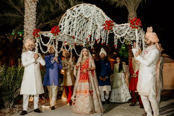 Grand bridal entry under a big phoolon ki chaadar