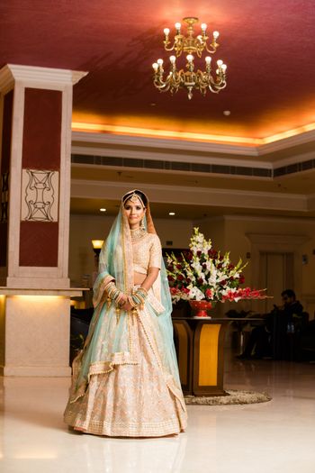 Photo of Pastel bride in light blue and peach lehenga