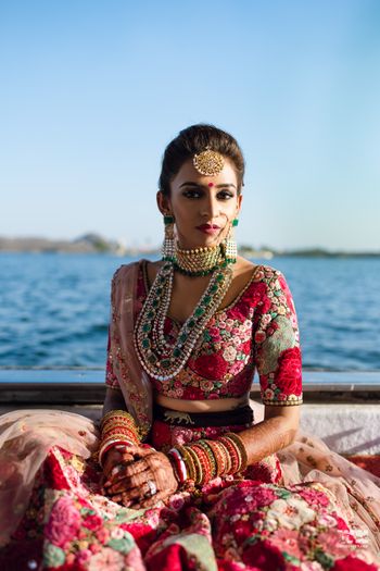 Photo of A perfect bridal portrait showcasing jewellery and lehenga