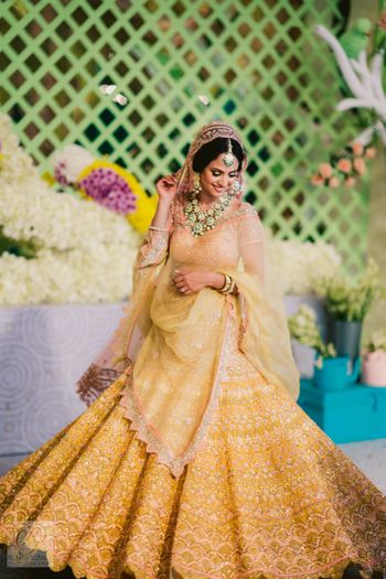 Beautiful bride in a yellow lehenga for her haldi 
