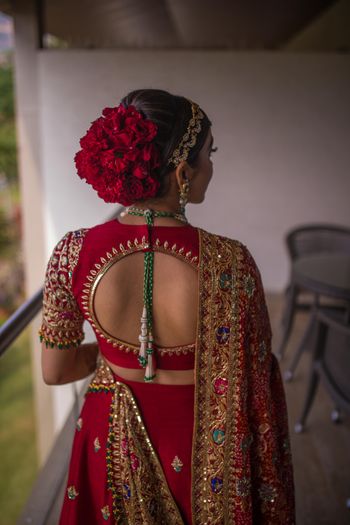 Photo of Stunning bridal bun with red roses