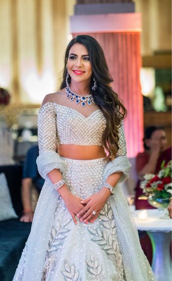 Photo of Pretty off shoulder blouse with silver lehenga