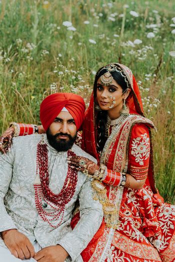 A happy couple posing after their wedding ceremony