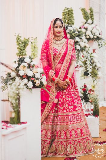 Photo of Red and gold Sabyasachi bridal lehenga on bride