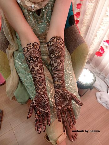 beautiful and traditional mehendi design on hands 