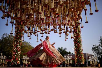 Photo of Bride twirling around under her mandap.