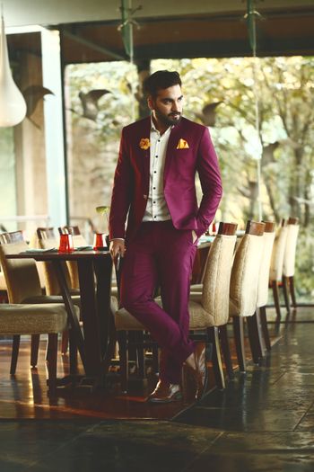 Offbeat groom wine coloured suit 