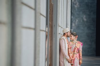 Photo of South Indian couple in coordinated outfit caught in a candid moment.