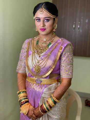 Photo of An elegant bridal shot in Bengali saree and temple jewellery.