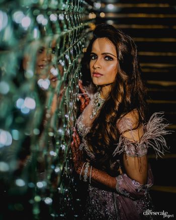 Bride wearing a feathery mauve lehenga.