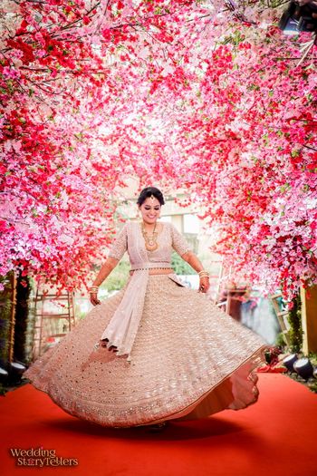 Photo of Twirling bride in silver lehenga and pretty decor