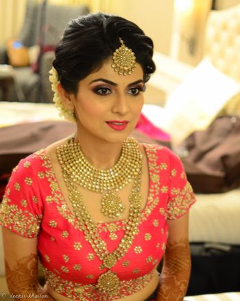 Gold finish jewellery bridal look with pink lehenga
