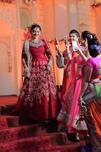 red anarkali bridal wear full sleeves with beige dupatta . threadowrk