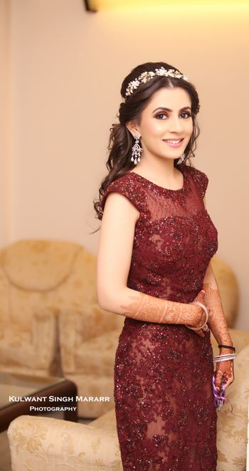 Bride wearing tiara style head band with maroon gown