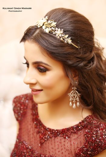 Bride wearing tiara style hair accessory with gown