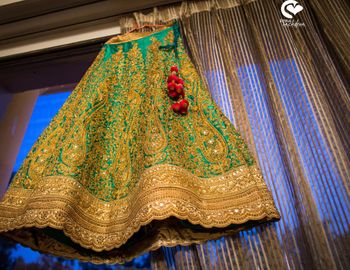 Green and gold lehenga on hanger in room