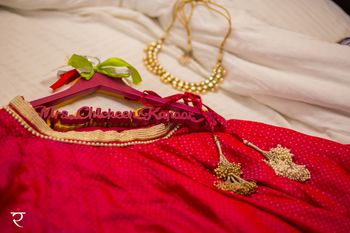 Getting ready shot with bridal hanger accessory