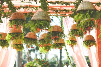 suspended cane baskets with floral decor over the mandap