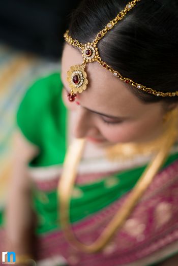 Photo of Minimal bridal mathapatti with red stones