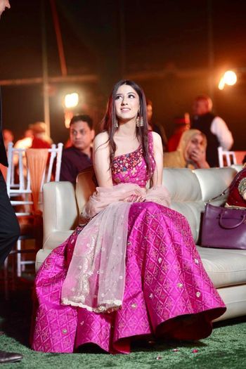 Photo of Bride dressed in a pink bandhani lehenga.